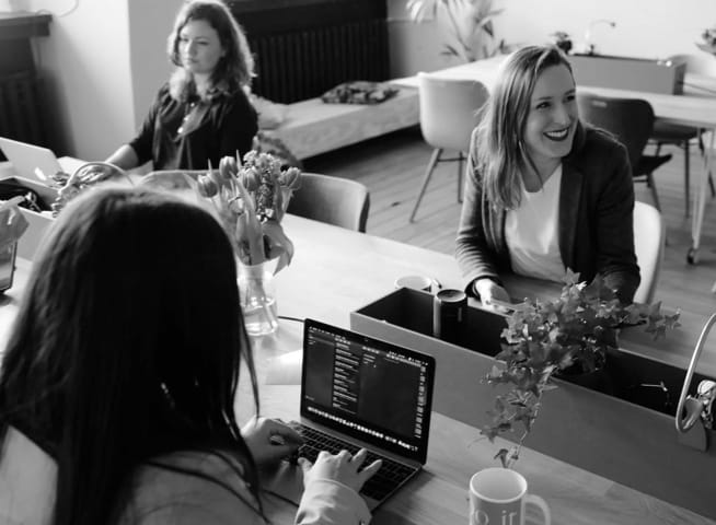 Women in an office on their laptops